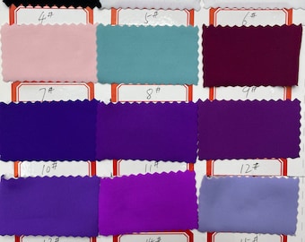 May include: Swatch card with 15 fabric samples in various colors, including black, white, pink, blue, purple, and red. The samples are numbered 1 through 15.