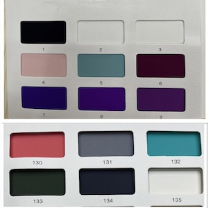 May include: A color swatch card featuring fifteen rectangular samples arranged in two sections. The top section displays colors numbered 1 through 9, including black, white, pink, teal, and shades of purple. The bottom section shows colors 130 through 135, featuring red, gray, turquoise, dark green, navy, and white.