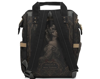 May include: A black backpack featuring a printed illustration of Dracula and Mina Harker on the back panel. The bag includes black shoulder straps, a top handle, and the text "DRACULA & MINA HARKER" printed in a decorative gold frame design.