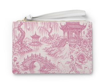 May include: A rectangular wristlet pouch featuring a pink and white toile-style print. The design depicts a landscape with pagodas, a stone bridge, willow trees, roses, and three ghost figures. The pouch includes a white wrist strap and a gold zipper.