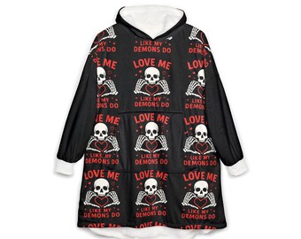 May include: A black hooded sweatshirt with a white interior lining, featuring a repeating pattern of white skulls with skeletal hands forming a heart shape, accompanied by the red text "LOVE ME LIKE MY DEMONS DO" printed across the front.