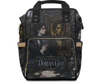 May include: A black backpack featuring a graphic print inspired by The Picture of Dorian Gray, including portraits, book titles, and text. The bag has a top handle, a front zippered pocket, and side pockets with beige trim and gold-tone zippers.