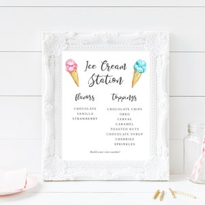 May include: A white framed sign with the text "Ice Cream Station" and a list of ice cream flavors and toppings. The sign features a pink and blue ice cream cone on each side.
