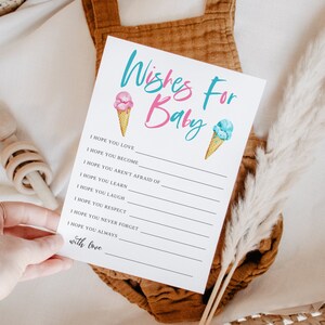 K&ouml;nnte beinhalten: Eine wei&szlig;e Karte mit dem Text "Wishes For Baby" in rosa und blauen Buchstaben. Die Karte hat ein rosa Eiswaffel mit einem blauen Eiswaffel auf der rechten Seite. Die Karte enth&auml;lt eine Liste von W&uuml;nschen f&uuml;r ein Baby, wie z. B. "Ich hoffe, du liebst", "Ich hoffe, du wirst", "Ich hoffe, du hast keine Angst vor", "Ich hoffe, du lernst", "Ich hoffe, du lachst", "Ich hoffe, du respektierst", "Ich hoffe, du vergisst nie", "Ich hoffe, du bist immer", und "mit Liebe".