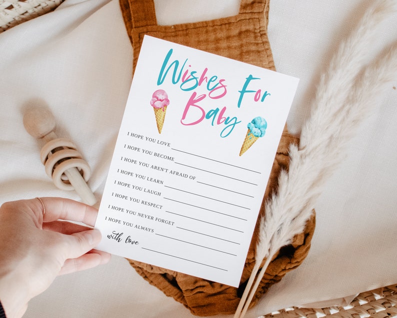 K&ouml;nnte beinhalten: Eine wei&szlig;e Karte mit dem Text "Wishes For Baby" in rosa und blauen Buchstaben. Die Karte hat ein rosa Eiswaffel mit einem blauen Eiswaffel auf der rechten Seite. Die Karte enth&auml;lt eine Liste von W&uuml;nschen f&uuml;r ein Baby, wie z. B. "Ich hoffe, du liebst", "Ich hoffe, du wirst", "Ich hoffe, du hast keine Angst vor", "Ich hoffe, du lernst", "Ich hoffe, du lachst", "Ich hoffe, du respektierst", "Ich hoffe, du vergisst nie", "Ich hoffe, du bist immer", und "mit Liebe".