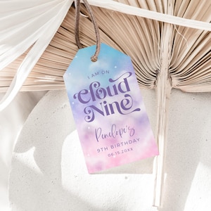 May include: A purple and pink watercolor tag with the text "I am on Cloud Nine Penelope's 9th Birthday 08.15.20XX" printed on it.