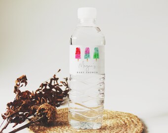May include: A clear plastic water bottle with a white label featuring three colorful popsicle illustrations and the text "Megan's Baby Shower".