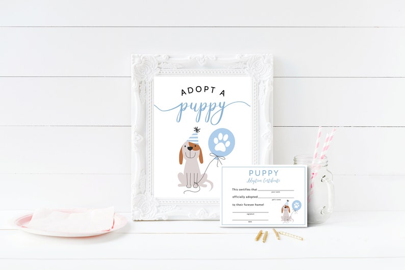 May include: Adopt a Puppy sign with a cartoon puppy wearing a party hat and holding a blue balloon with a paw print. A printable puppy adoption certificate is also included.