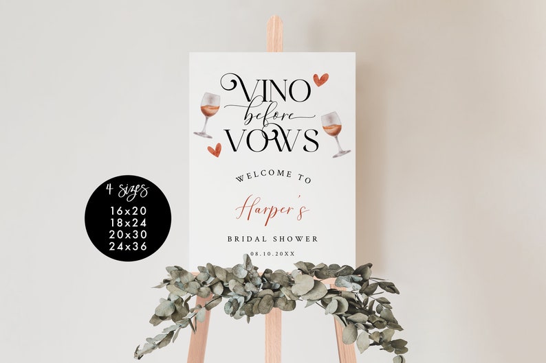 Pode incluir: Um cartaz branco com o texto "VINO before VOWS" em letra cursiva preta com duas ta&ccedil;as de vinho e cora&ccedil;&otilde;es vermelhos. O texto "WELCOME TO Harper's BRIDAL SHOWER 08.10.20XX" est&aacute; em preto e vermelho. O cartaz est&aacute; em um cavalete de madeira.