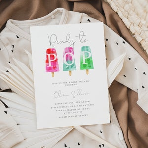 May include: A white baby shower invitation with a watercolor illustration of three popsicles with the letters "POP" on them. The text "Ready to POP" is written in cursive at the top of the invitation. The invitation includes the date, time, and location of the baby shower.