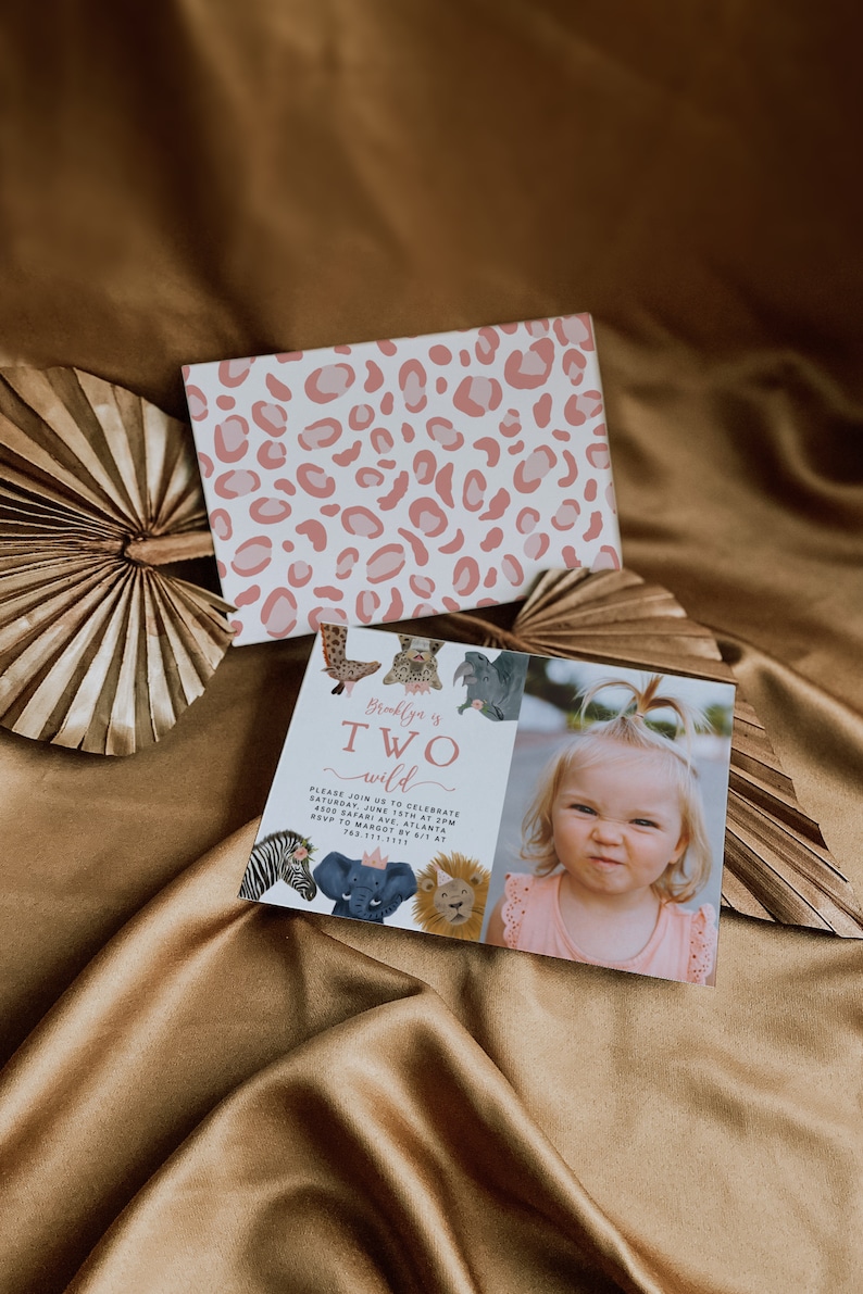 May include: A pink and white leopard print invitation card with a photo of a young girl. The card says "Brooklyn is TWO wild" and includes details for a birthday party.