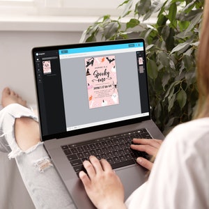May include: A laptop computer displaying a pink and black Halloween party invitation with the text "Jasmine is a Spooky one" and "Jasmine's 1st Boo-Bash".