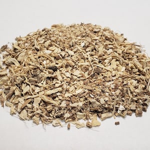 May include: A pile of dried, light brown and beige root bark, likely for use in herbal remedies or teas.