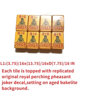 May include: Eight yellow Mahjong tiles with the words "BIG" and "JOKER" printed on them. Each tile features a replicated pheasant joker decal. The tiles are set on an aged bakelite background.