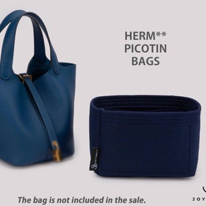 May include: A blue handbag with two handles and a matching blue insert. The handbag has a textured surface and a gold-colored clasp. The text "HERM** PICOTIN BAGS" is displayed above the insert. The text "The bag is not included in the sale" is displayed below.