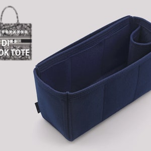 May include: A navy blue felt bag organizer with multiple compartments and a zippered pocket. The organizer is designed to fit inside a larger tote bag.