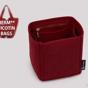 May include: A deep red felt bag organizer with a square base and multiple interior compartments. It features a zippered pocket with a gold-tone metal zipper pull. A black fabric tag with the white text JOYINBAG is attached to the side.