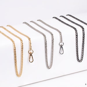 May include: Five different chain straps with lobster clasps. The chains are gold, silver, and black.