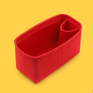May include: Red felt bag organizer with multiple compartments and a small pocket. The organizer is designed to fit inside a larger bag.