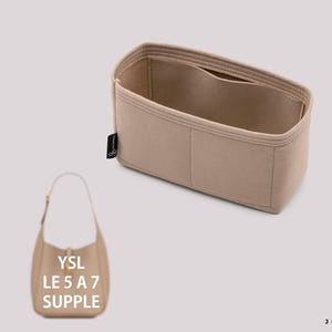 May include: A beige felt handbag organizer insert with multiple interior compartments and a small black side tag. Below, a beige shoulder bag is shown with the text YSL LE 5 A 7 SUPPLE printed on it, alongside a black logo reading JOYINBAG.