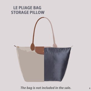 May include: A beige and navy blue storage pillow for a Le Pliage bag, with brown leather handles and a flap. The text "LE PLIAGE BAG STORAGE PILLOW" is at the top. The text "The bag is not included in the sale" is at the bottom.