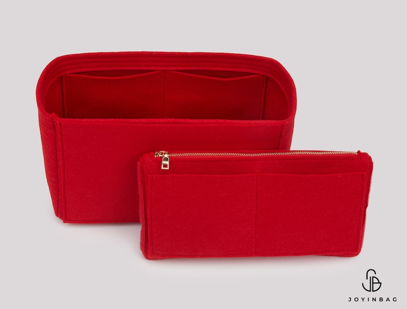 May include: Red felt bag organiser with multiple compartments and a zipped pouch. The organiser is designed to fit inside a larger bag, keeping items organised and easy to find.