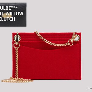 May include: A rectangular red felt bag organiser insert featuring a gold-tone metal chain strap attached to two circular rings on the top corners. The insert has a flat front pocket and is designed for the Mulbe*** Small Willow Clutch.