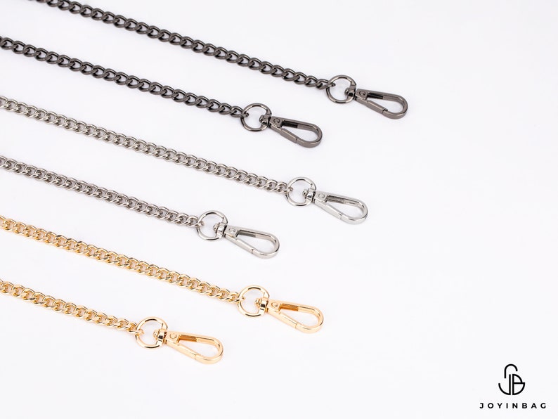 May include: Four different chain straps with lobster clasps. The chains are silver, gold, and two shades of gunmetal.