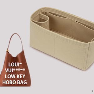 May include: A brown leather hobo bag with the text "LOUI* VUI****** LOW KEY HOBO BAG" printed on the front.