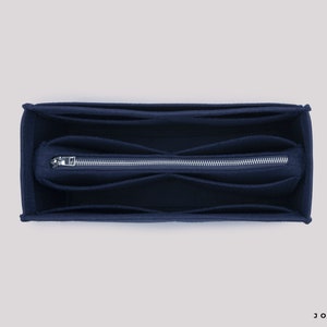 May include: A dark blue felt bag organizer with multiple compartments and a zipper closure. The organizer is designed to fit inside a larger bag.