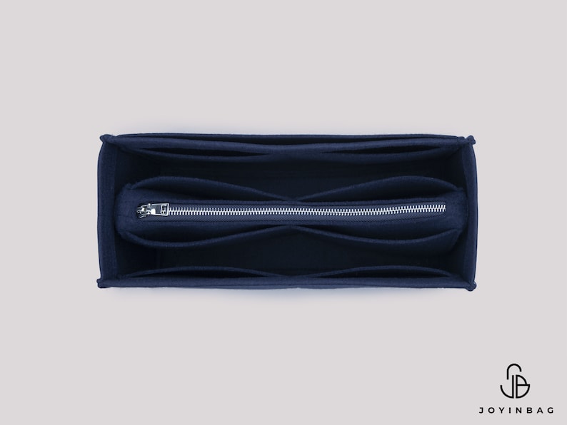 May include: A dark blue felt bag organizer with multiple compartments and a zipper closure. The organizer is designed to fit inside a larger bag.