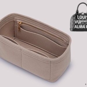May include: Beige felt bag organizer with multiple compartments and a zippered pocket. The organizer is designed to fit inside a Louis Vuitton Alma BB handbag. The bag organizer has a Joyinbag logo on the side.