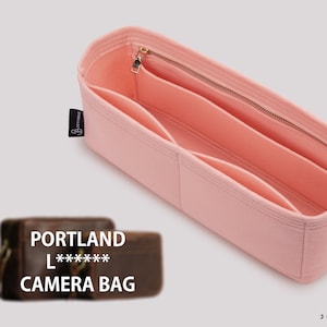 Peut inclure: Organiseur de sac à main en feutre rose avec plusieurs compartiments et une fermeture à glissière. L'organisateur est étiqueté "JOYINBAG" et porte une petite étiquette noire avec le texte "JOYINBAG".