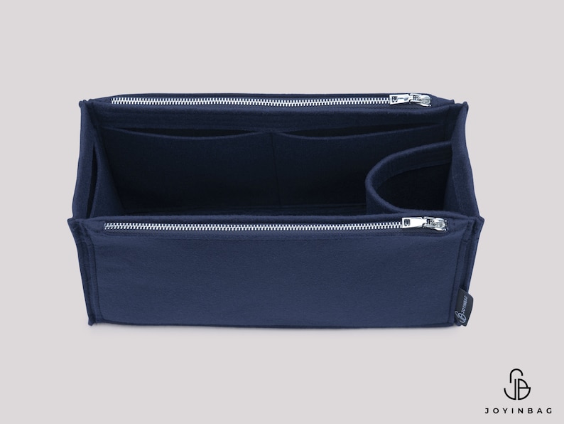 May include: A navy blue felt bag organiser with multiple compartments and a zipper closure. The organiser is designed to fit inside a larger bag.