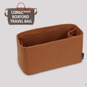 May include: A brown felt bag organizer with multiple compartments and a zippered pocket. The organizer is designed to fit inside a Longchamp Boxford Travel Bag.