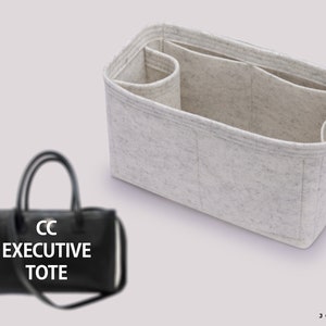 May include: A black tote bag with the text "CC EXECUTIVE TOTE" on the front. The bag is shown with a beige felt organiser insert.
