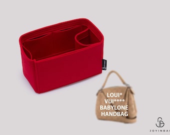 May include: A rectangular red felt handbag organizer insert with multiple interior compartments and a small black side tag labeled JOYINBAG. Next to it is a blurred tan handbag with the text LOUI* VUI**** BABYLONE HANDBAG printed on it.
