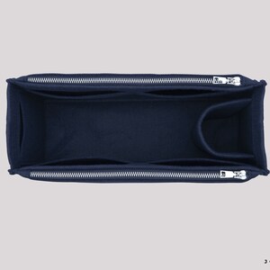 May include: A navy blue felt bag organiser with two zipped compartments and a smaller pocket. The organiser is designed to fit inside a larger bag.