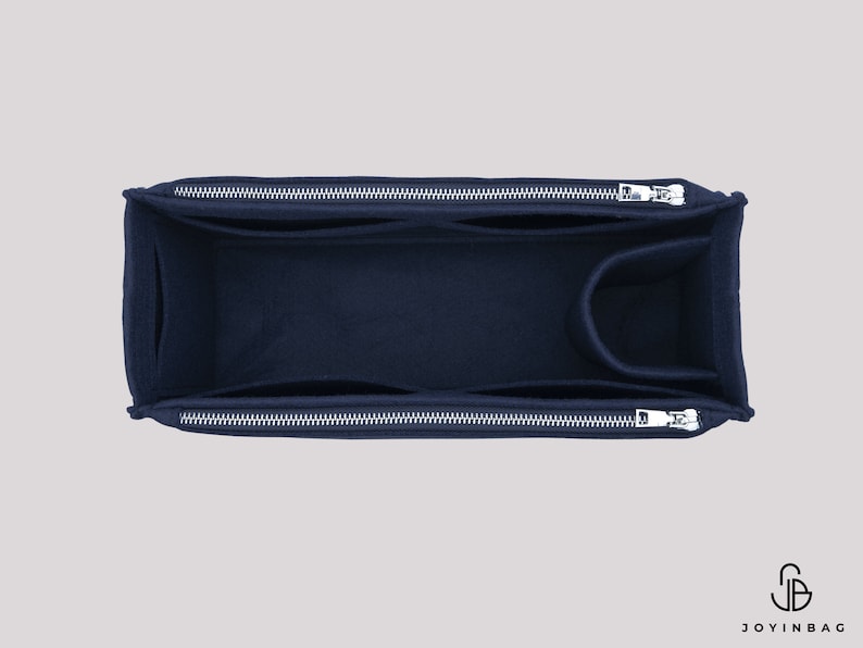 May include: A navy blue felt bag organiser with two zipped compartments and a smaller pocket. The organiser is designed to fit inside a larger bag.