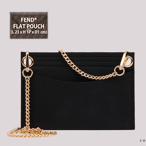 May include: A black felt bag organiser insert featuring a gold-tone metal chain strap attached to two circular rings. The insert has a rectangular shape with a top pocket opening and is designed for a Fend* flat pouch measuring 23 cm x 17 cm x 1 cm.