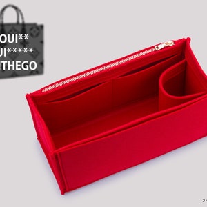 May include: Red felt bag organizer with multiple compartments and a zipper closure. The organizer is designed to fit inside a Louis Vuitton OnTheGo tote bag.