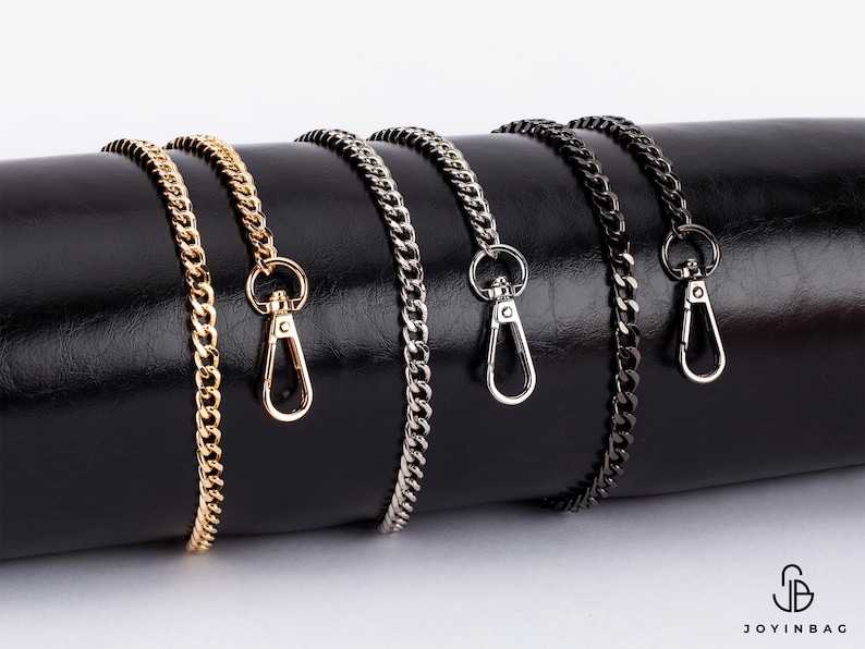 May include: Four different chain bag straps with lobster clasps. The chains are gold, silver, black, and gunmetal.