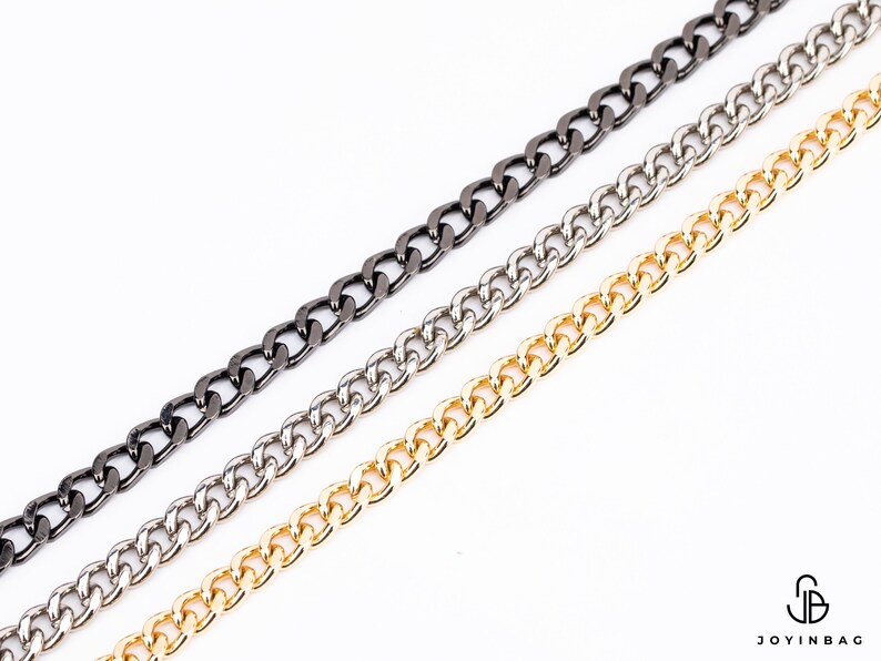May include: Three chains in different finishes: black, silver, and gold. The chains are all the same style, with a curb link design.
