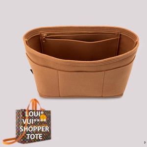 May include: A tan-colored bag organizer with multiple pockets and a zippered top. The organizer is designed to fit inside a tote bag. A small tote bag with the text "LOUI* VUI***** SHOPPER TOTE" is also visible.