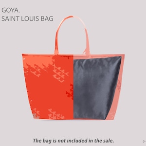 May include: An orange tote bag with a gray interior, featuring the text "GOYA. SAINT LOUIS BAG." The bag has a rectangular shape with a handle. The text "The bag is not included in the sale" is also visible.