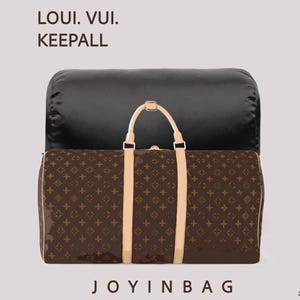 May include: A brown duffel bag with a repeating monogram pattern, light tan leather handles, and gold-tone hardware. The text LOUI. VUI. KEEPALL appears in the upper left corner, and the text JOYINBAG is centered at the bottom.
