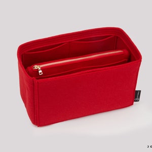 May include: Red felt bag organiser with multiple compartments and a zipped pocket. The organiser has a gold zipper and a small black label with the text "Joyinbag".