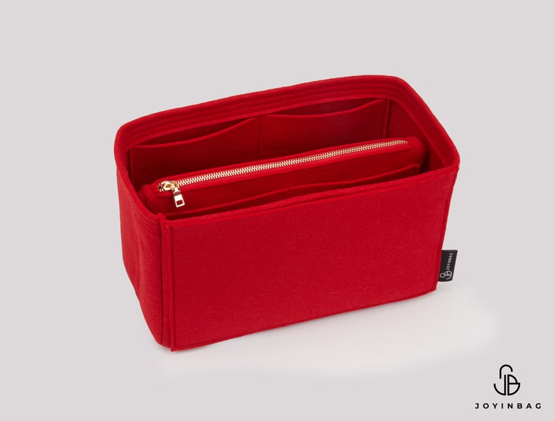 May include: Red felt bag organiser with multiple compartments and a zipped pocket. The organiser has a gold zipper and a small black label with the text "Joyinbag".