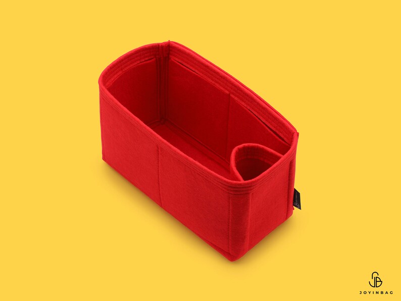 May include: Red felt bag organizer with multiple compartments and a small pocket. The organizer is designed to fit inside a larger bag.