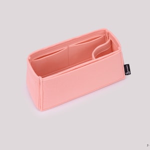 May include: A pink felt bag organizer with multiple compartments and a small black label with the text "Joyinbag".